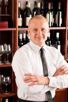 Wine bar waiter male in restaurant posing with cross arms
