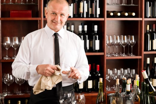 At the bar - waiter clean glass with dish clove restaurant