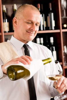 Wine bar happy waiter pour white wine in glass restaurant