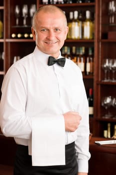 Wine bar waiter mature smiling in restaurant front of counter
