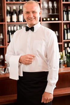 Wine bar waiter mature smiling in restaurant front of counter