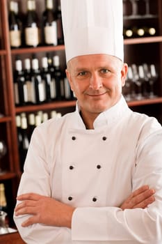 Chef cook confident professional posing in restaurant cross arms