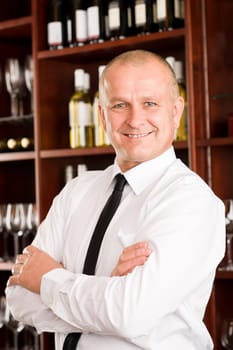 Wine bar waiter male in restaurant posing with cross arms