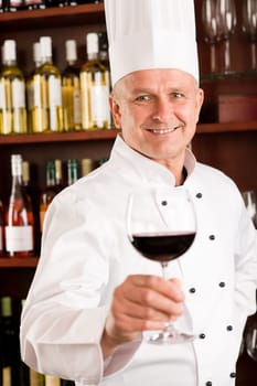 Chef cook wine bar professional hold glass confident in restaurant