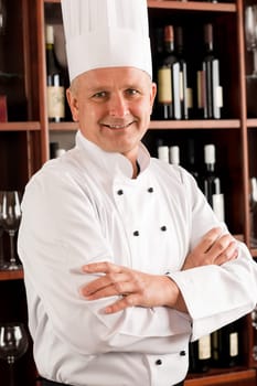 Chef cook confident professional posing in restaurant cross arms