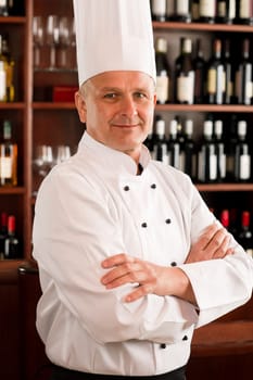 Chef cook confident professional posing in restaurant cross arms