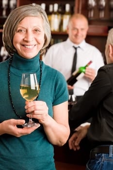 Wine bar senior woman manager enjoy drink smiling barman discussing