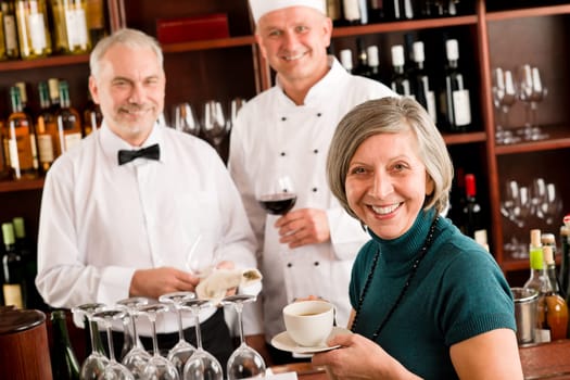 Restaurant smiling manager have break with staff wine bar