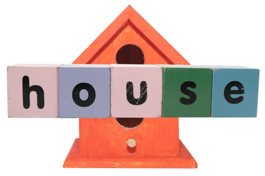 toy letters that spell house against a birdhouse with clipping path