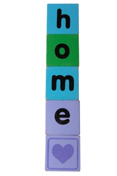 toy letters that spell home against a white background with clipping path with a heart shape