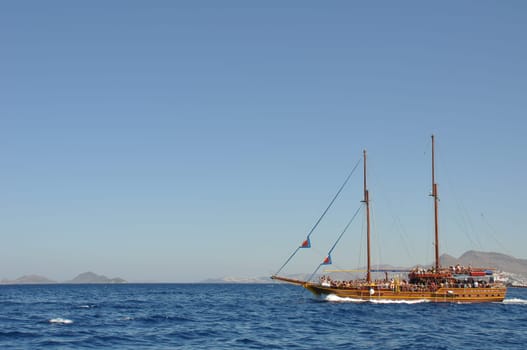 KOS - AUGUST 26 2010: passengers on board, antique ship is cruising the blue sea on August 26, 2010 in Kos, GREECE