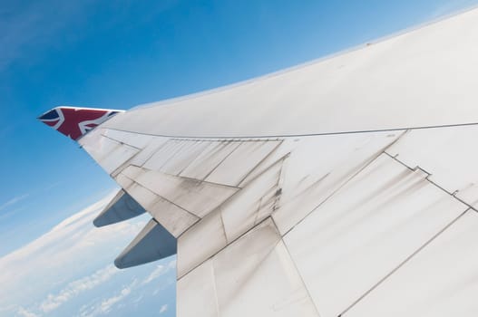 ST JOHNS, ANTIGUA - AUGUST 17: view of Boeing 747 wing of Virgin Atlantic Airways with blue sky clouds close to V. C. Bird International Airport in Antigua on August 17, 2011 in St. John&#039 s, Antigua