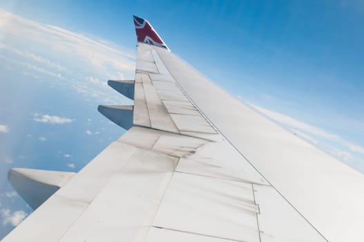 ST JOHNS, ANTIGUA - AUGUST 17: view of Boeing 747 wing of Virgin Atlantic Airways with blue sky clouds close to V. C. Bird International Airport in Antigua on August 17, 2011 in St. John&#039 s, Antigua