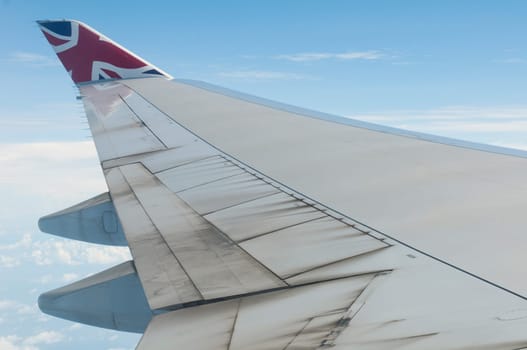 ST JOHNS, ANTIGUA - AUGUST 17: view of Boeing 747 wing of Virgin Atlantic Airways with blue sky clouds close to V. C. Bird International Airport in Antigua on August 17, 2011 in St. John&#039 s, Antigua