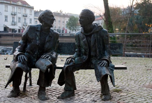 TOMAR, PORTUGAL - DECEMBER 15:  Mouchão Garden bench, bronze statues giving tribute to two sons of Tomar, Fernando Lopes Graça and Fernando Araújo Ferreira on December 15, 2011 in Tomar, Portugal
