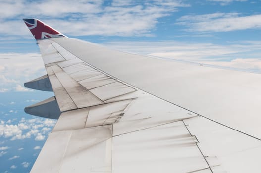 ST JOHNS, ANTIGUA - AUGUST 17: view of Boeing 747 wing of Virgin Atlantic Airways with blue sky clouds close to V. C. Bird International Airport in Antigua on August 17, 2011 in St. John&#039 s, Antigua