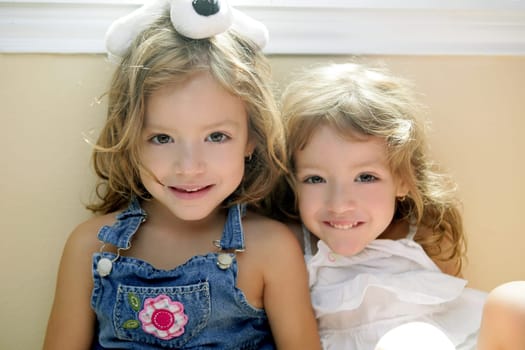 Two little beautiful toddler twin sisters portrait