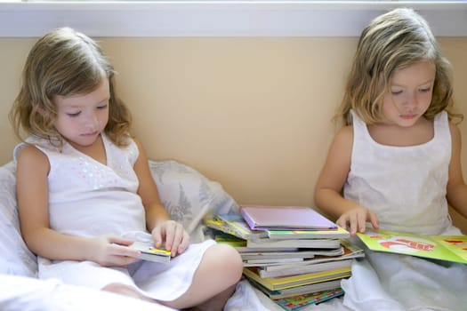 Beautiful twin little girls doing school homework at home