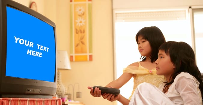 two asian girls dressed as princess, tv remote control, blue copy space