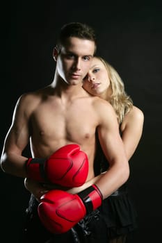 Sexy young male boxer with blond beautiful girl, isolated on black studio shot
