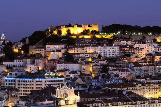 Historic mediterranean architecture with church at night with light in Lisboa, Portugal