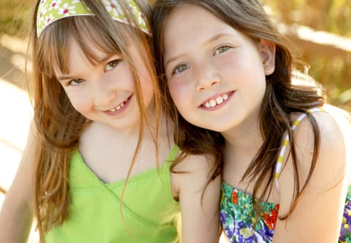 Two sister happy together in outdoors at the park
