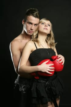 Sexy young male boxer with blond beautiful girl, isolated on black studio shot