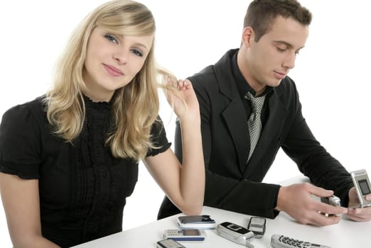 Business couple with many mobile telephones, isolated over white