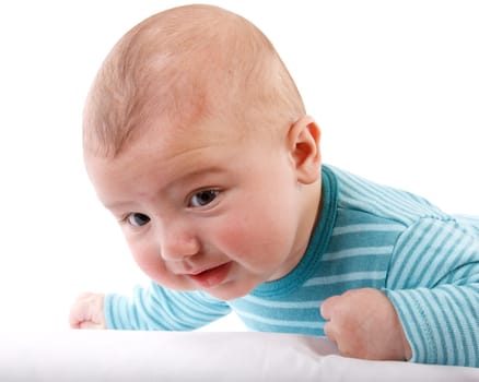 The nice small child in striped rompers lays on a stomach on a white background.
