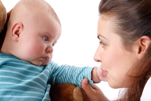 Happy mum plays with the small child a white background.