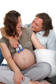 The young family expecting a birth of the child, holds bootees
