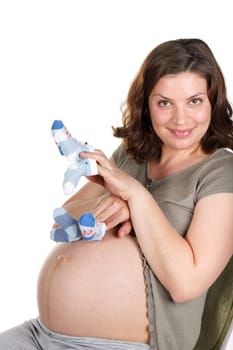 The young pregnant woman expecting a birth of the child, holds bootees