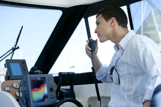 Young handsome man on a yacht boat interior in summer