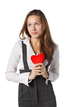 The beautiful girl holds in hands a red heart on a white background.