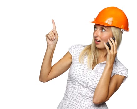 Female architect in a hard hat talks by a mobile phone on a white background.