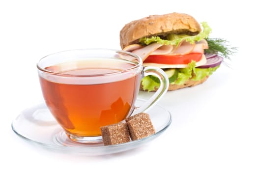 Ham sandwich and cup of tea on a white background. Close up.