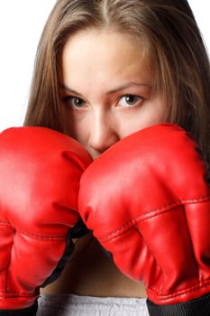 Sporty girl in red fighting gloves on a white background.