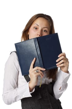 The beautiful young girl with a diary on a white background.