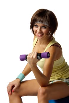 The beautiful sports girl with dumbbells on a white background. Training.