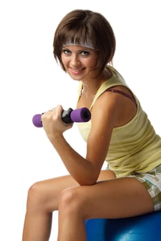 The beautiful sports girl with dumbbells on a white background. Training.