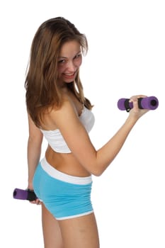 The beautiful sports girl with dumbbells on a white background. Training.