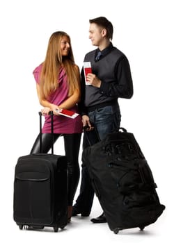 Happy young family with suitcases and tickets on a white background. Vacation.