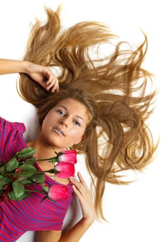 The beautiful girl with a bouquet of roses on a white background.
