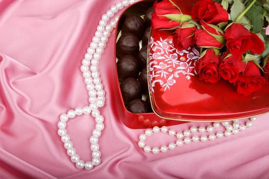 Heart-shaped red box with sweets and flowers. Valentine&#039 s day card.