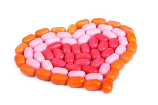 Heart from candies on a white background