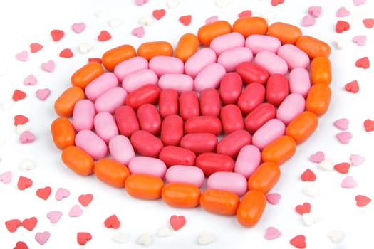 Heart from candies on a white background