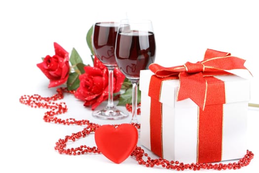 Gift box with red ribbon and flower on a white background