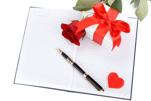 Gift box, rose and organizer on a white background