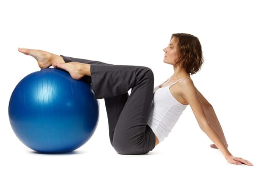 Young beautiful woman with gymnastic ball on a white background.