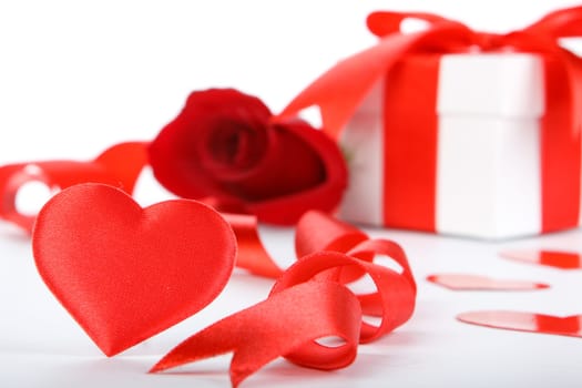 Gift box and rose on a white background. Valentine&#039 s day card.